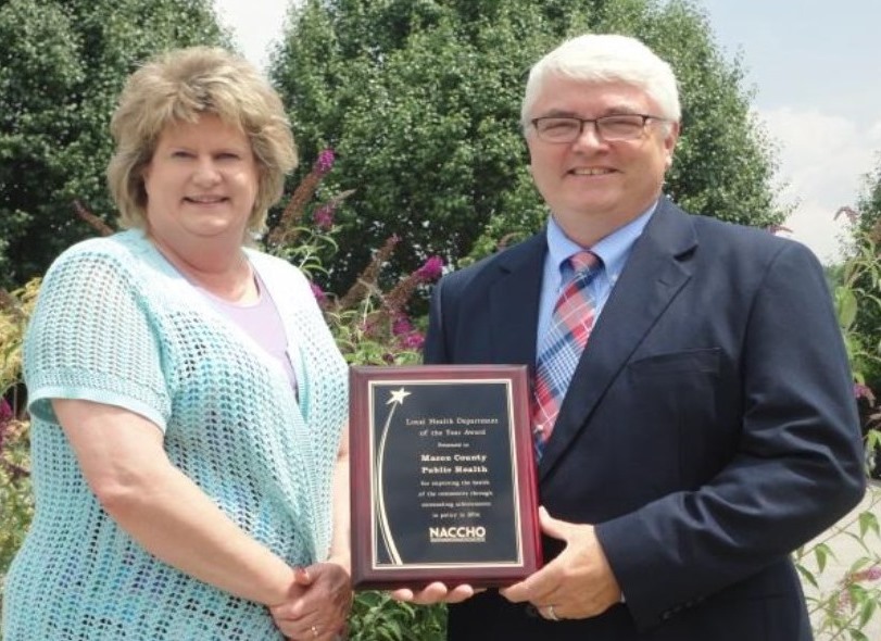 Macon County Public Health has been awarded the -
Small Health Department of the Year - Award by the National Association of County and City Health Officials (NACCHO).
This national award was presented to Health Director, Mr. Jim Bruckner at the NACCHO National Conference in Atlanta on
July 9th. Macon County Public Health received the award for its successful efforts to enact tobacco control
policies in Macon County. Shown with Mr. Bruckner is Dawn Wilde, Community Health Promotions Supervisor, at Macon
County Public Health.